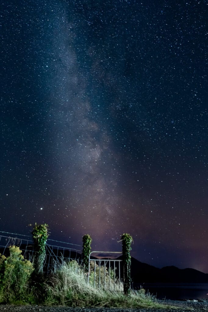 Milky Way above Bunaw in County Kerry, Ireland, with a light-painted gate and vegetation beneath the star-filled night sky